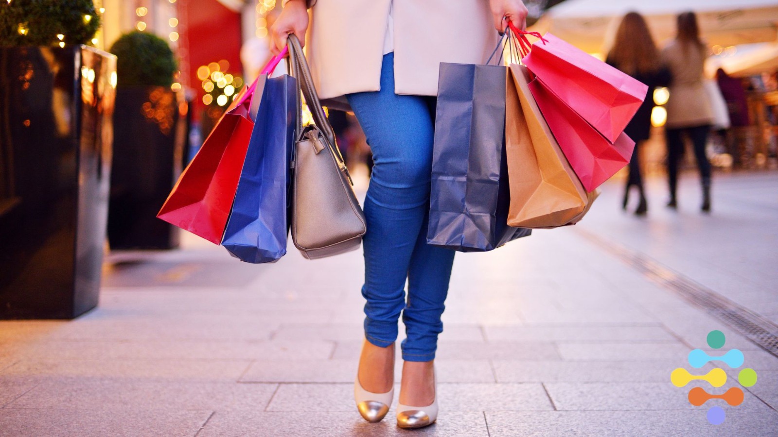 Mujer con varias bolsas de compras en la mano.